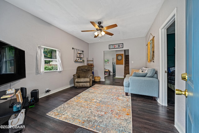 living room featuring dark wood-style floors, ceiling fan, and baseboards