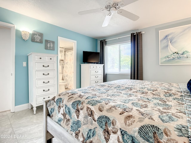 bedroom with ensuite bathroom, ceiling fan, and a textured ceiling