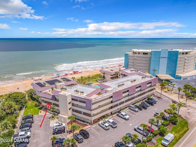 drone / aerial view with a beach view and a water view