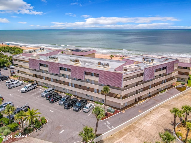 birds eye view of property featuring a view of the beach and a water view