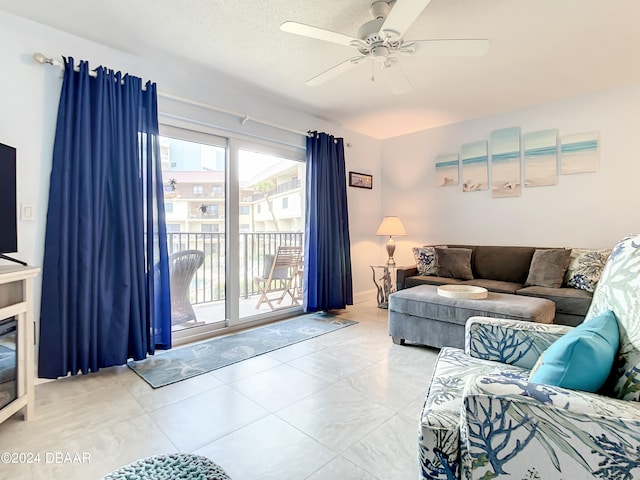 living room featuring a textured ceiling and ceiling fan