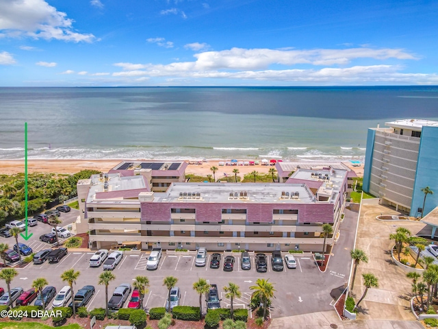 birds eye view of property with a water view and a view of the beach