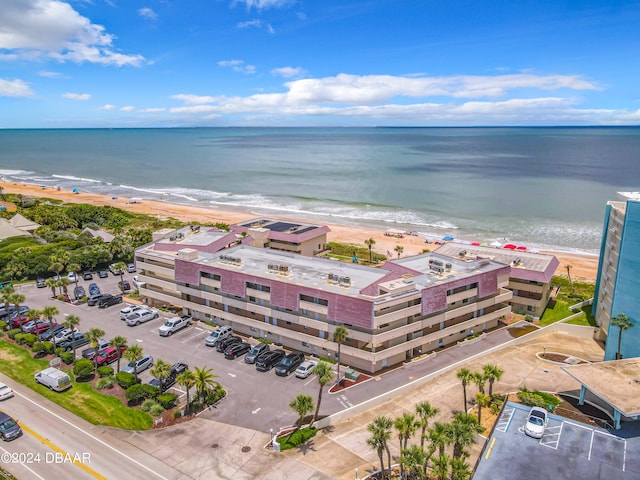 birds eye view of property featuring a beach view and a water view