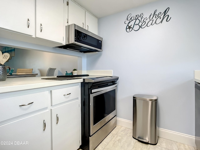 kitchen with white cabinetry and appliances with stainless steel finishes