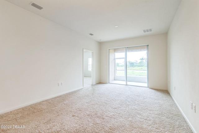 unfurnished room featuring light colored carpet