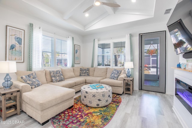 living room with light hardwood / wood-style flooring, lofted ceiling with beams, and ceiling fan