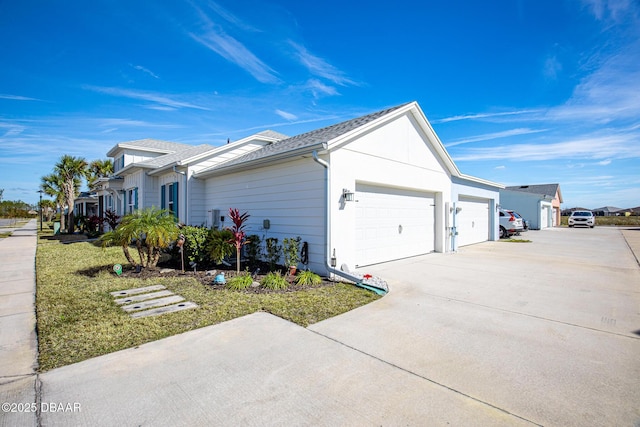 view of side of home with a garage and a lawn