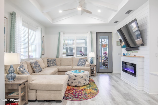 living room featuring coffered ceiling, ceiling fan, vaulted ceiling with beams, and light wood-type flooring