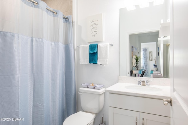 bathroom featuring vanity, a shower with curtain, and toilet