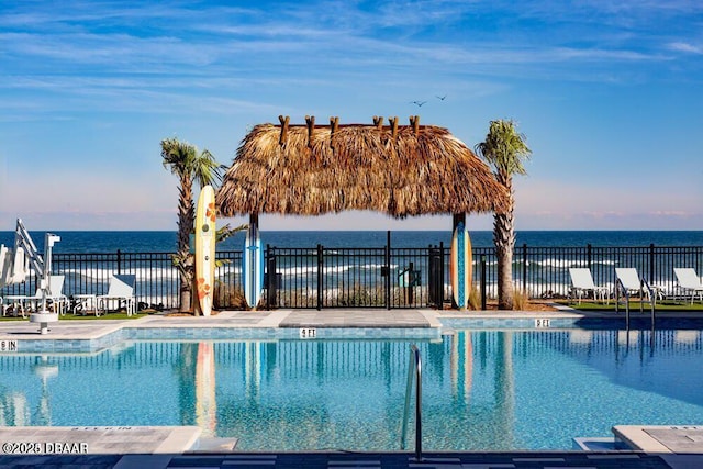 view of swimming pool featuring a water view, a patio area, and a gazebo