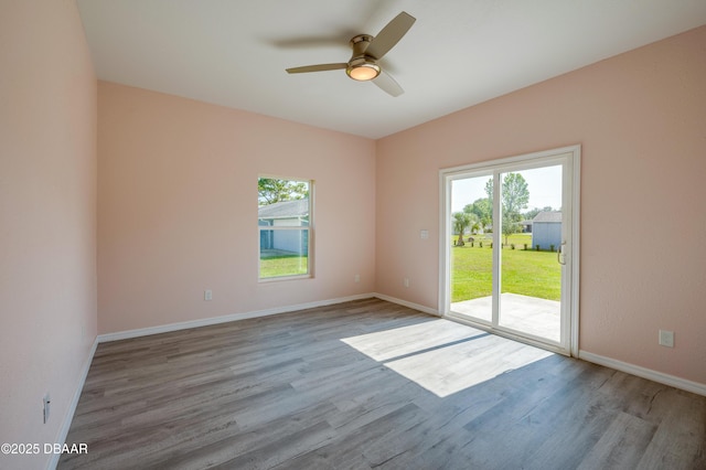 707 Hamilton St, New Smyrna Beach, FL 32168 - empty room with plenty of natural light, ceiling fan, wood finished floors, and baseboards