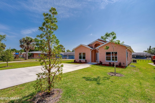 707 Hamilton St, New Smyrna Beach, FL 32168 - ranch-style home with driveway and a front lawn