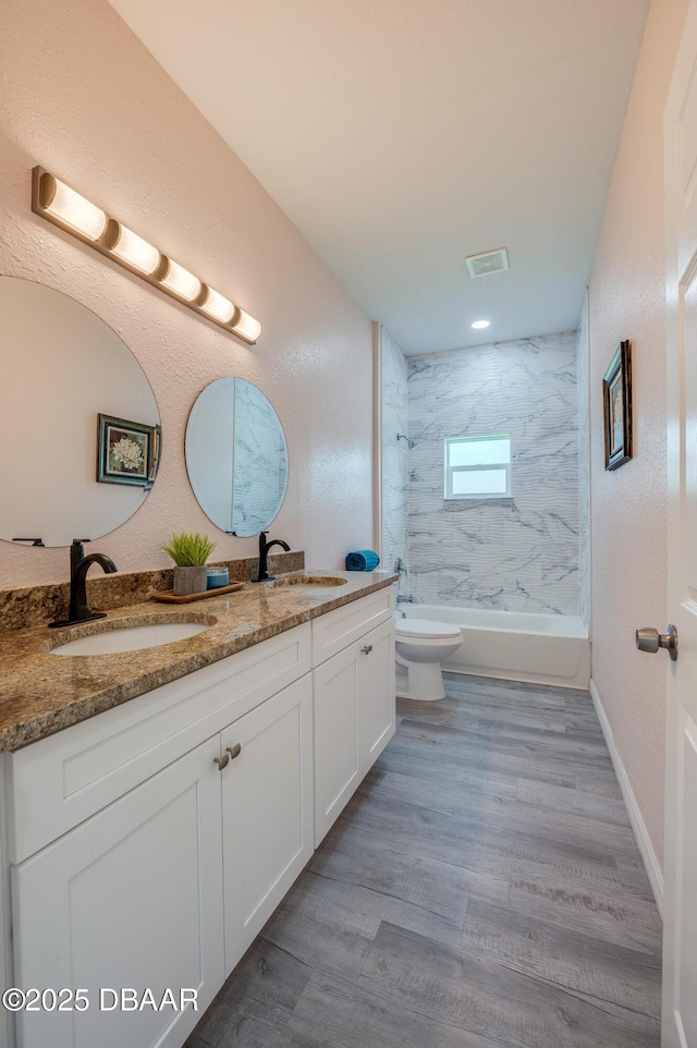 707 Hamilton St, New Smyrna Beach, FL 32168 - full bath featuring double vanity,  shower combination, toilet, and wood finished floors
