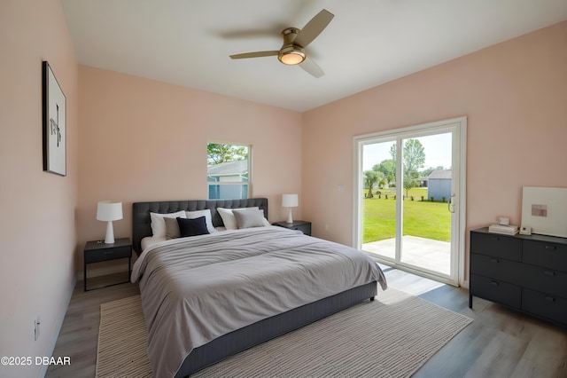 707 Hamilton St, New Smyrna Beach, FL 32168 - bedroom with light wood finished floors, access to exterior, and a ceiling fan