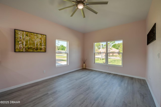 707 Hamilton St, New Smyrna Beach, FL 32168 - spare room featuring wood finished floors, a ceiling fan, and baseboards