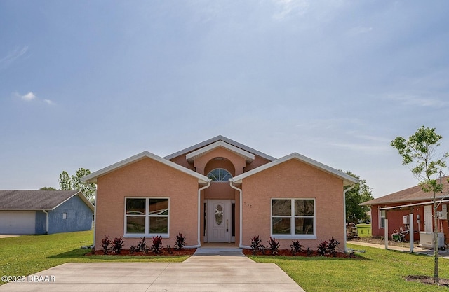 707 Hamilton St, New Smyrna Beach, FL 32168 - view of front of house with a front lawn and stucco siding
