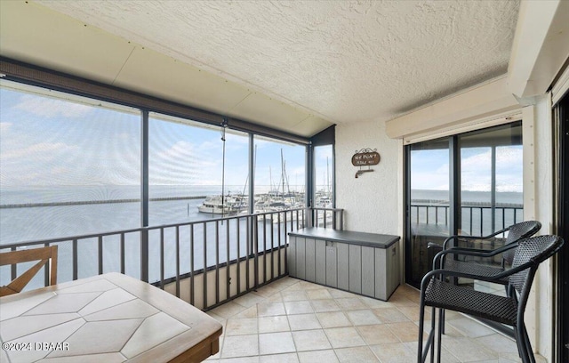 sunroom / solarium featuring a water view