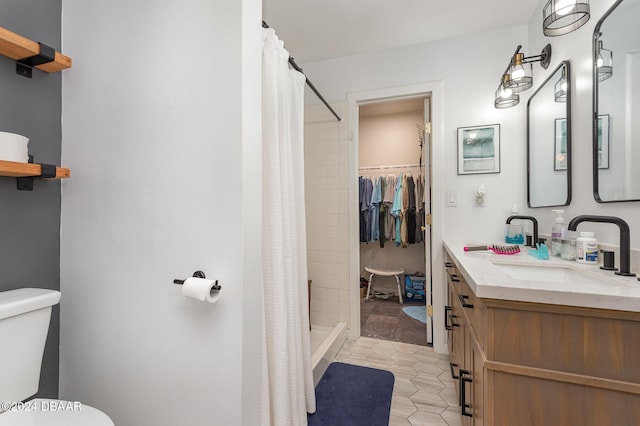 bathroom featuring tile patterned floors, vanity, curtained shower, and toilet