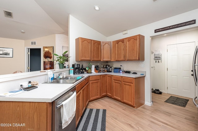 kitchen featuring dishwasher, kitchen peninsula, light hardwood / wood-style flooring, and lofted ceiling