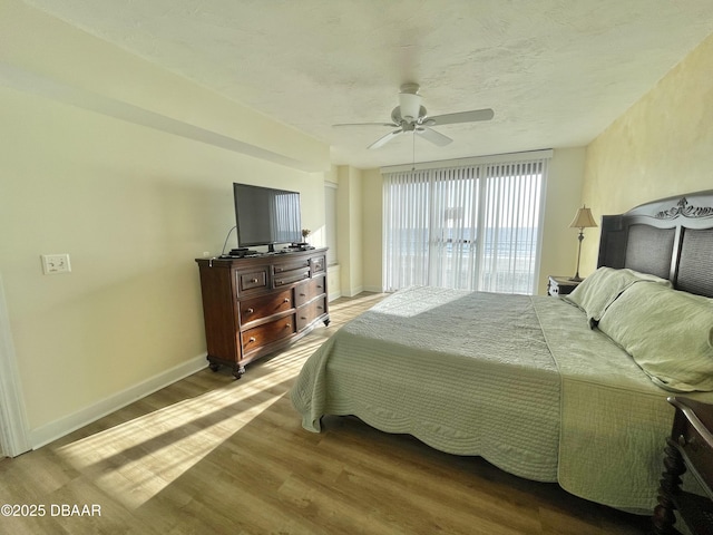 bedroom with ceiling fan and wood-type flooring