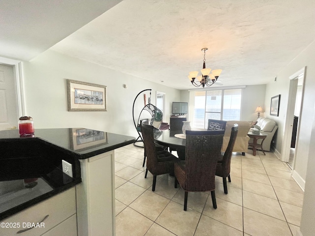 tiled dining room with a notable chandelier and a textured ceiling