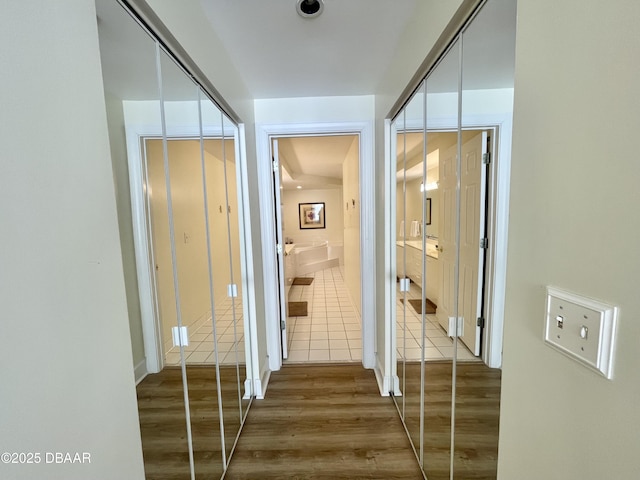 corridor with wood-type flooring