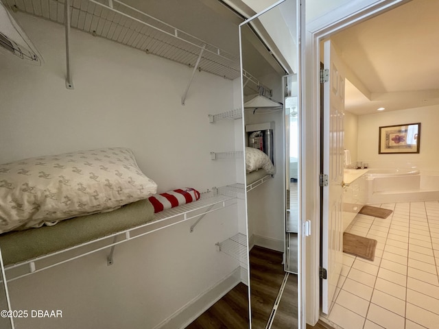 spacious closet featuring hardwood / wood-style floors