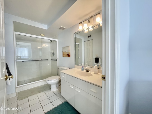 bathroom featuring toilet, tile patterned flooring, a shower with shower door, and vanity