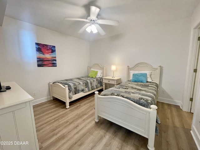 bedroom with light wood-type flooring and ceiling fan