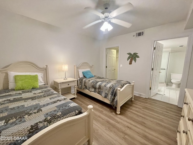 bedroom with ceiling fan, light hardwood / wood-style floors, and ensuite bath