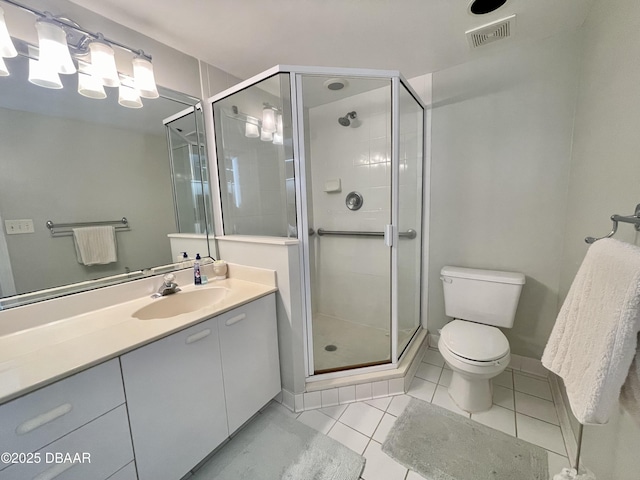 bathroom with a shower with shower door, tile patterned floors, toilet, and vanity