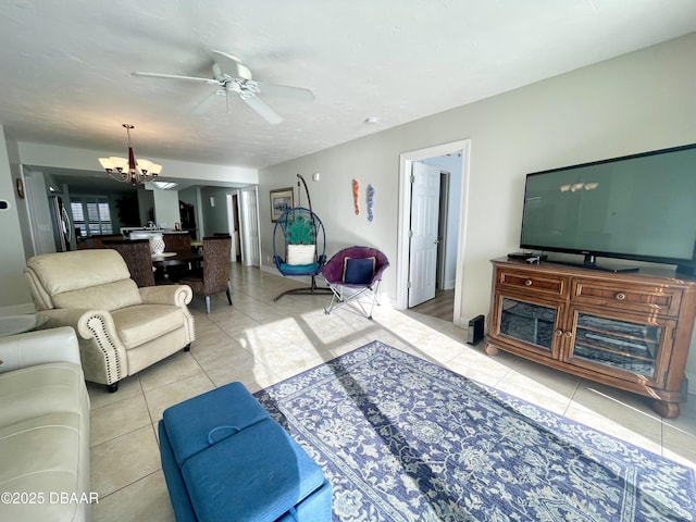 tiled living room with ceiling fan with notable chandelier