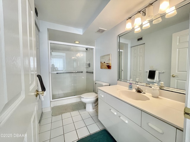 bathroom with vanity, walk in shower, tile patterned floors, and toilet