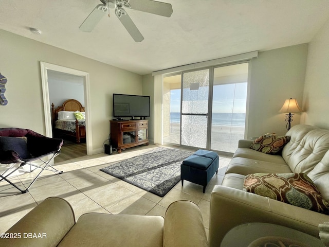 tiled living room with ceiling fan