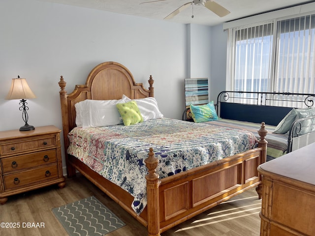 bedroom with dark wood-type flooring and ceiling fan