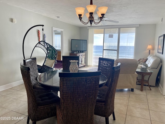 tiled dining space with an inviting chandelier and a textured ceiling