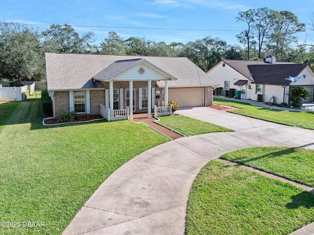 view of front of house featuring a garage, covered porch, and a front lawn