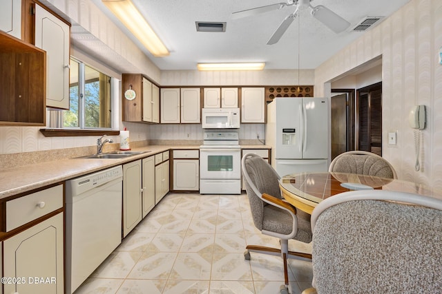 kitchen with a textured ceiling, white appliances, ceiling fan, sink, and light tile patterned floors