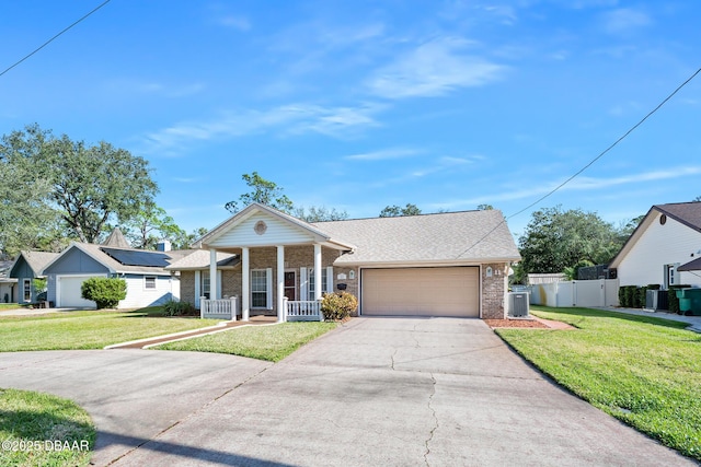 view of front of home featuring a front lawn, covered porch, central AC unit, and a garage