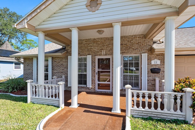 view of exterior entry featuring a porch