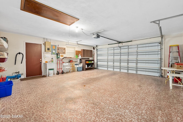 garage featuring a garage door opener and electric panel