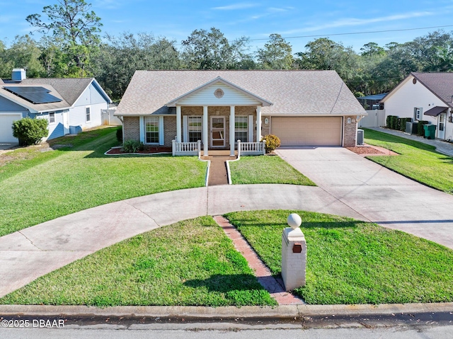 view of front of house with covered porch, a garage, and a front yard