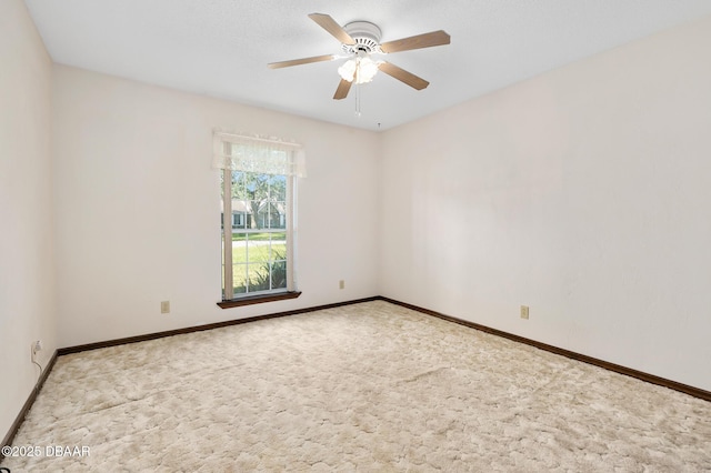 spare room with light colored carpet and ceiling fan