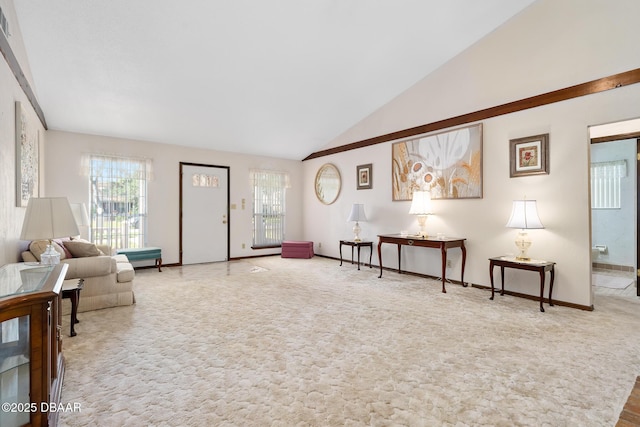 carpeted living room with vaulted ceiling