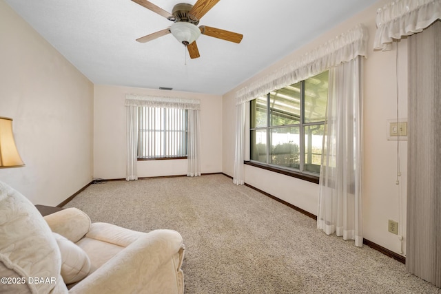 unfurnished room featuring ceiling fan and light carpet