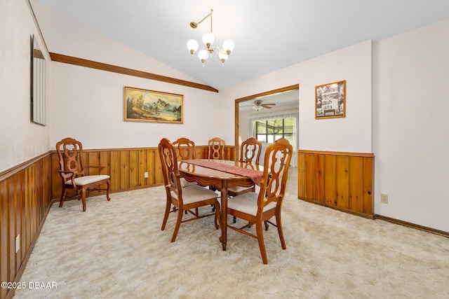 carpeted dining area with ceiling fan with notable chandelier and vaulted ceiling