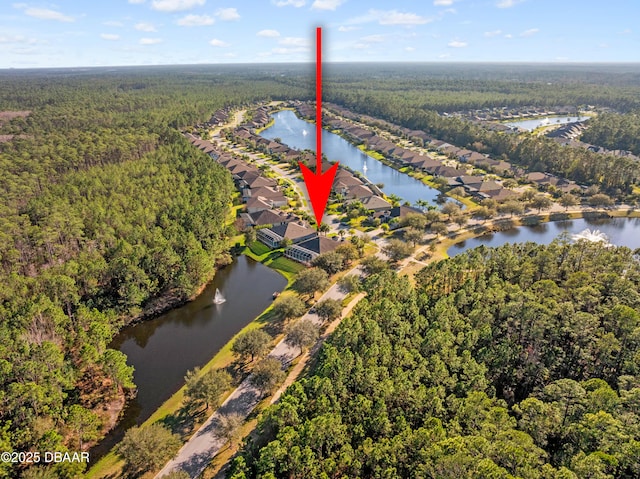 drone / aerial view with a water view and a view of trees