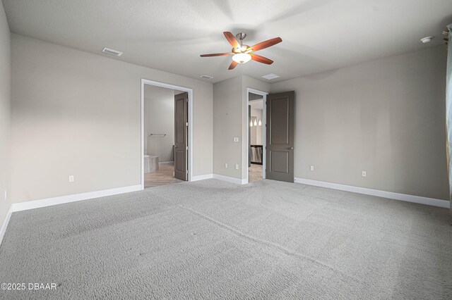 empty room featuring baseboards, visible vents, ceiling fan, and light colored carpet