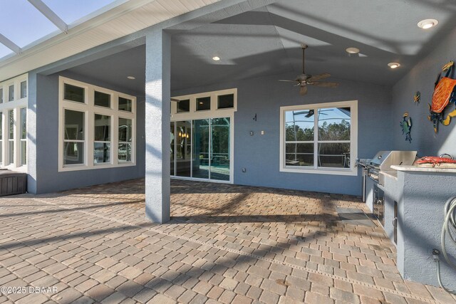 view of patio featuring area for grilling and a ceiling fan