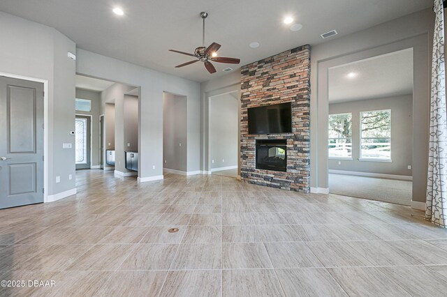 unfurnished living room featuring ceiling fan, recessed lighting, a fireplace, visible vents, and baseboards